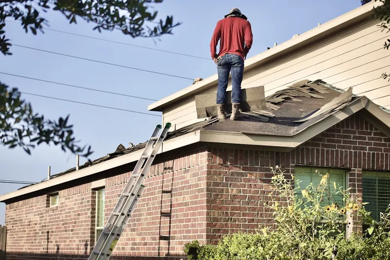 Professional roofer working on a residential roof in Pomona